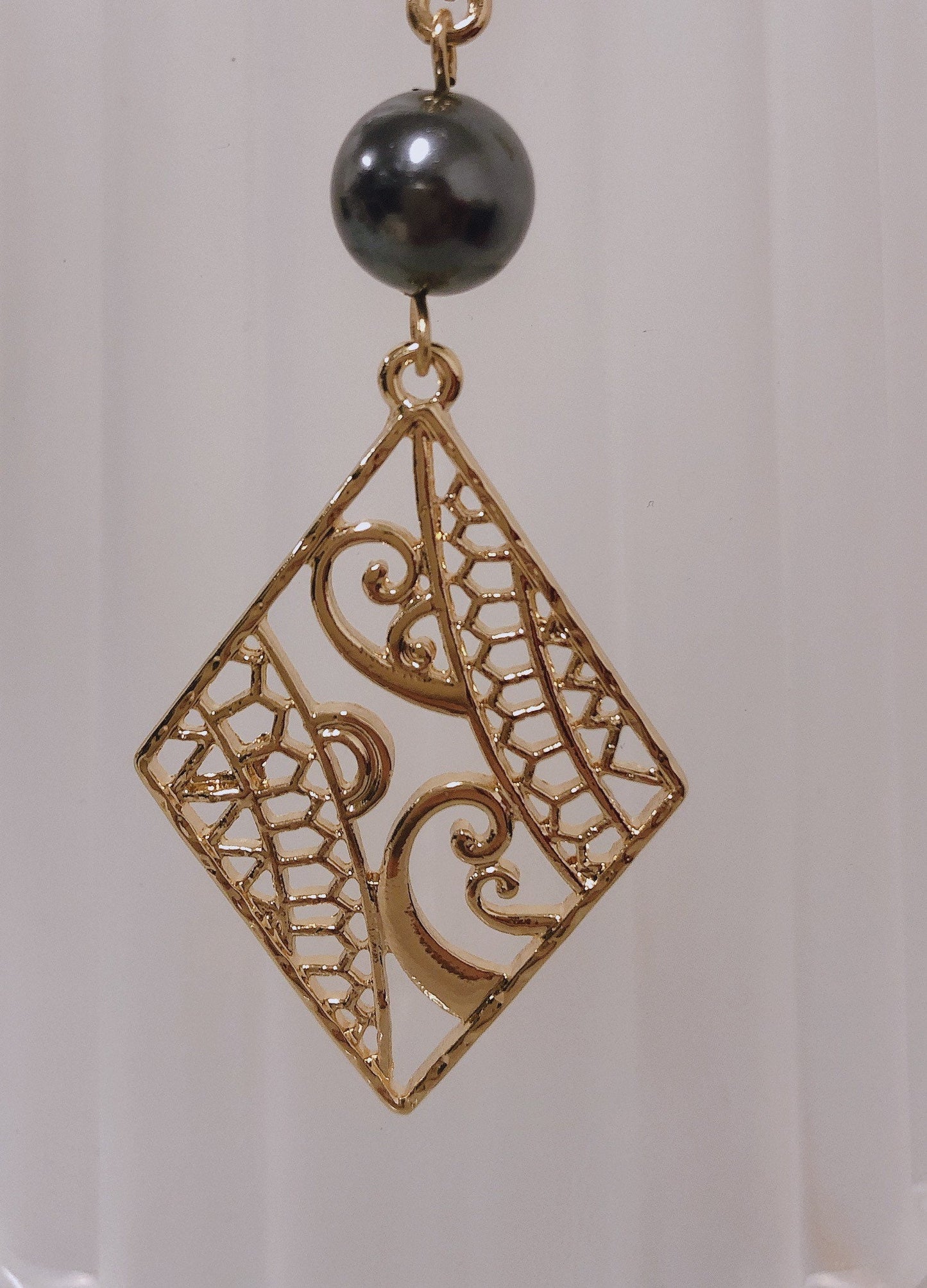 Hawaiian Wind Wave Tribal Design: Hamilton Gold Necklace with Shell Pearls