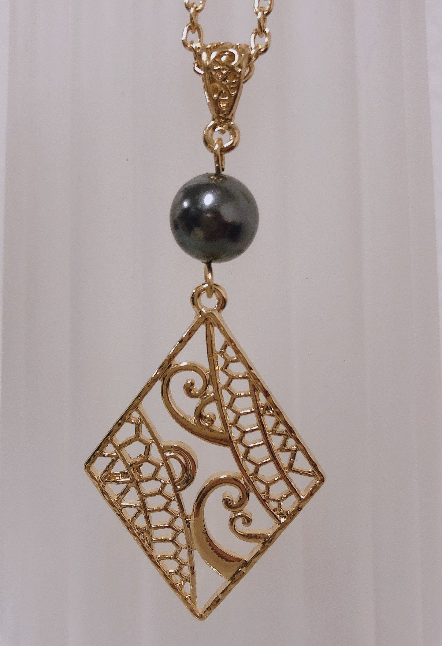 Hawaiian Wind Wave Tribal Design: Hamilton Gold Necklace with Shell Pearls