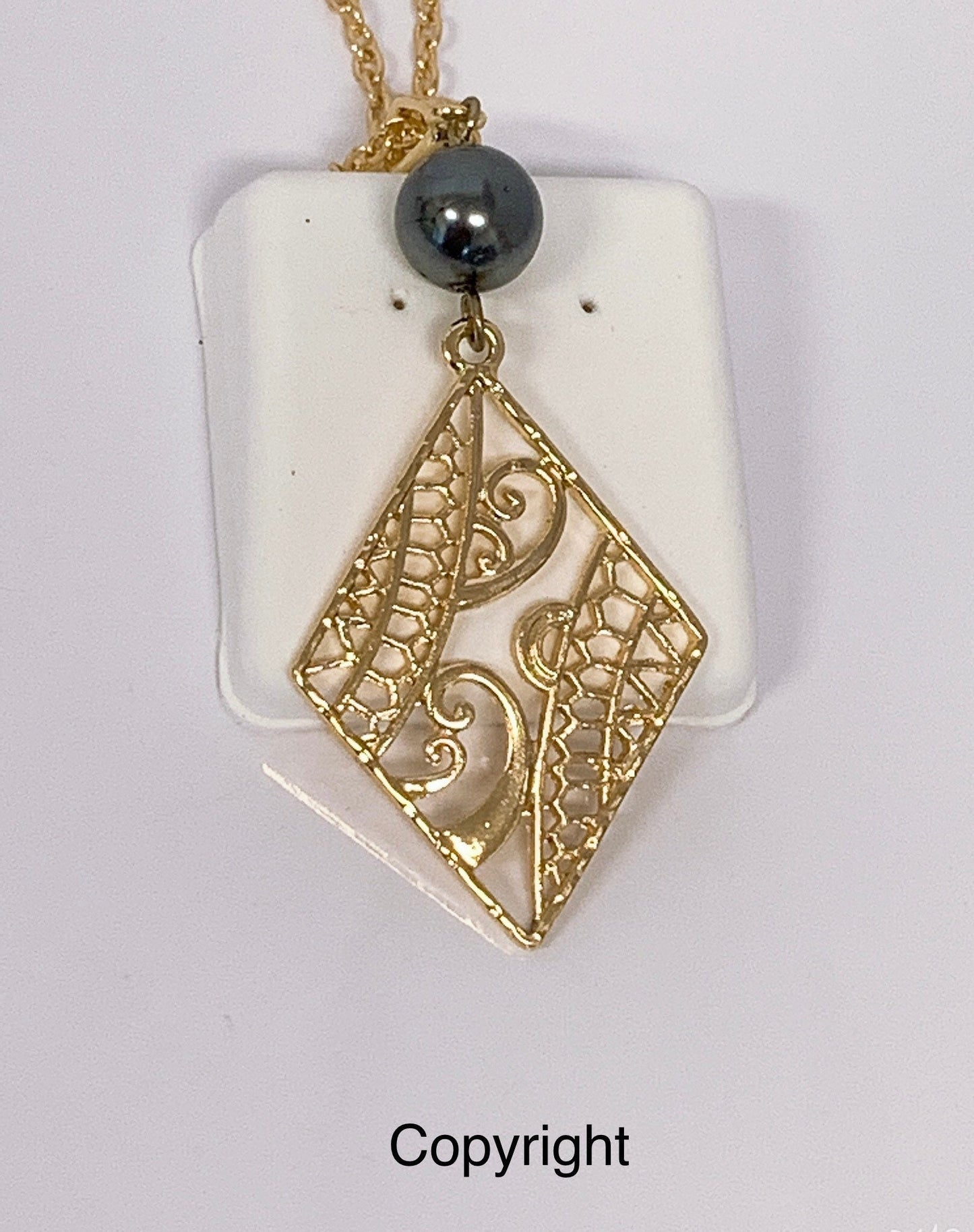 Hawaiian Wind Wave Tribal Design: Hamilton Gold Necklace with Shell Pearls